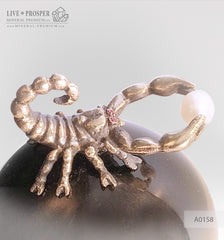 Bronze figure of scorpion on a Chrysoberyl sphere with sea pearl and Swarovski inserts on dolerite plate extra small Бронзовый скорпион на сфере из кошачьего глаза с морской жемчужиной и вставками из Сваровски на пластине из долерита -малый