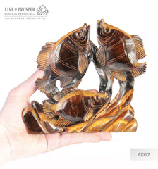 Solid tiger's eye carving of fish family playing under the sea on a wooden stand Стая рыб играющая на морском дне из тигрового глаза на деревянной подставке